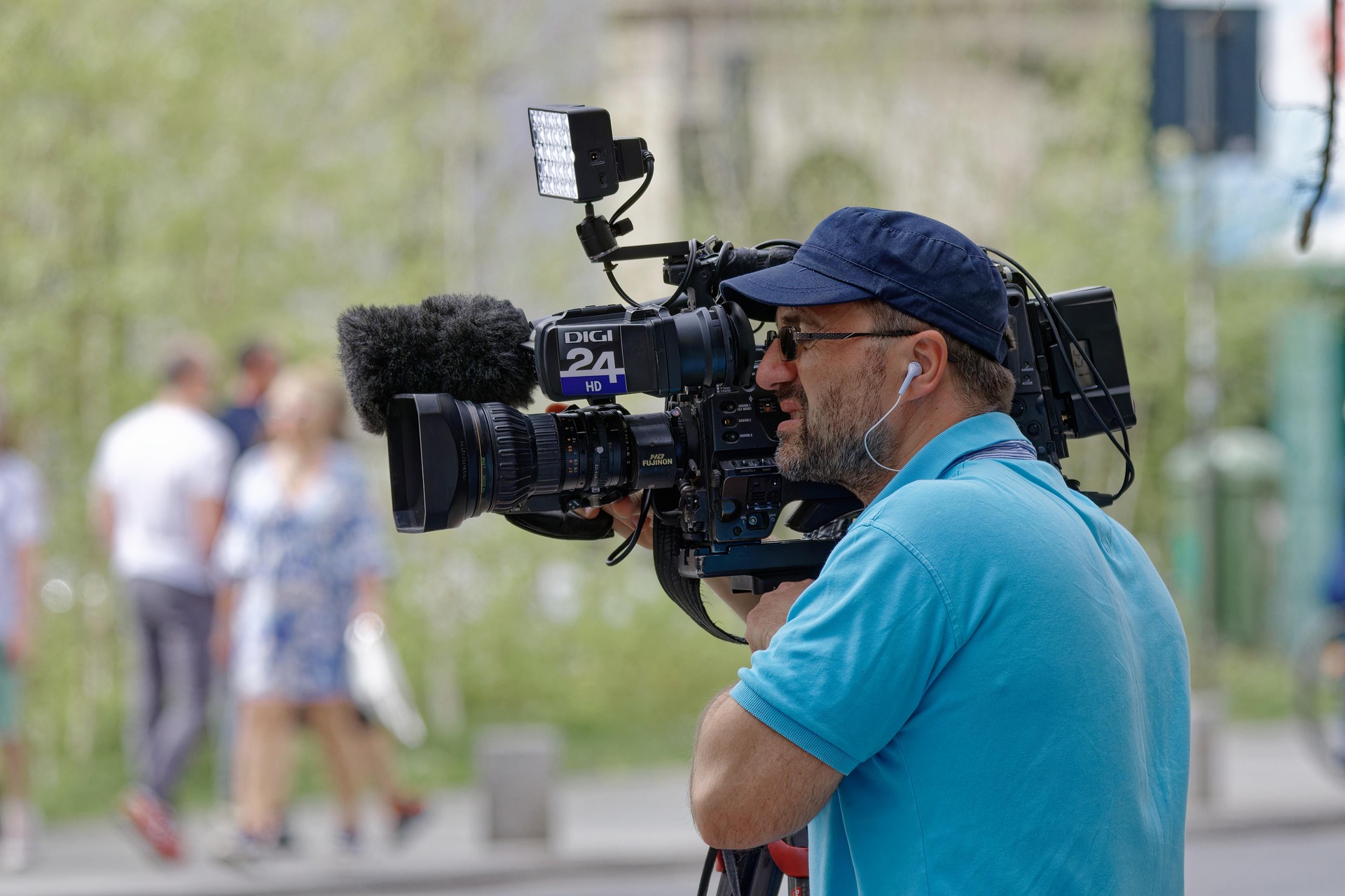 Cameraman at work with camera on shoulder